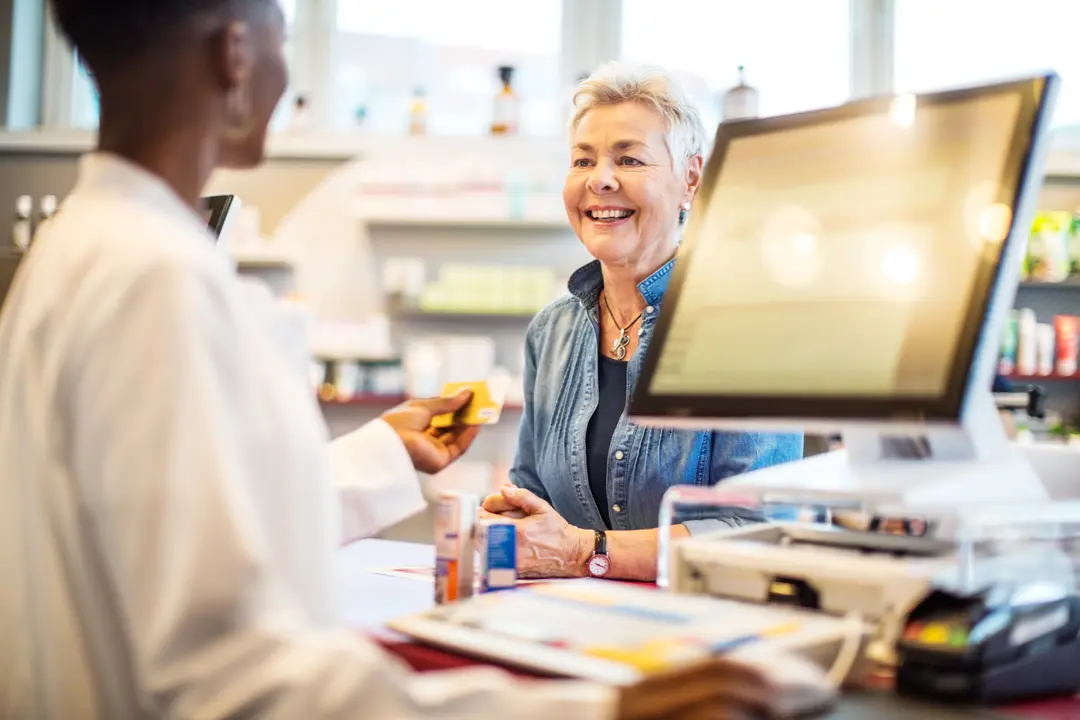 A pharmacist helping a customer at the counter
