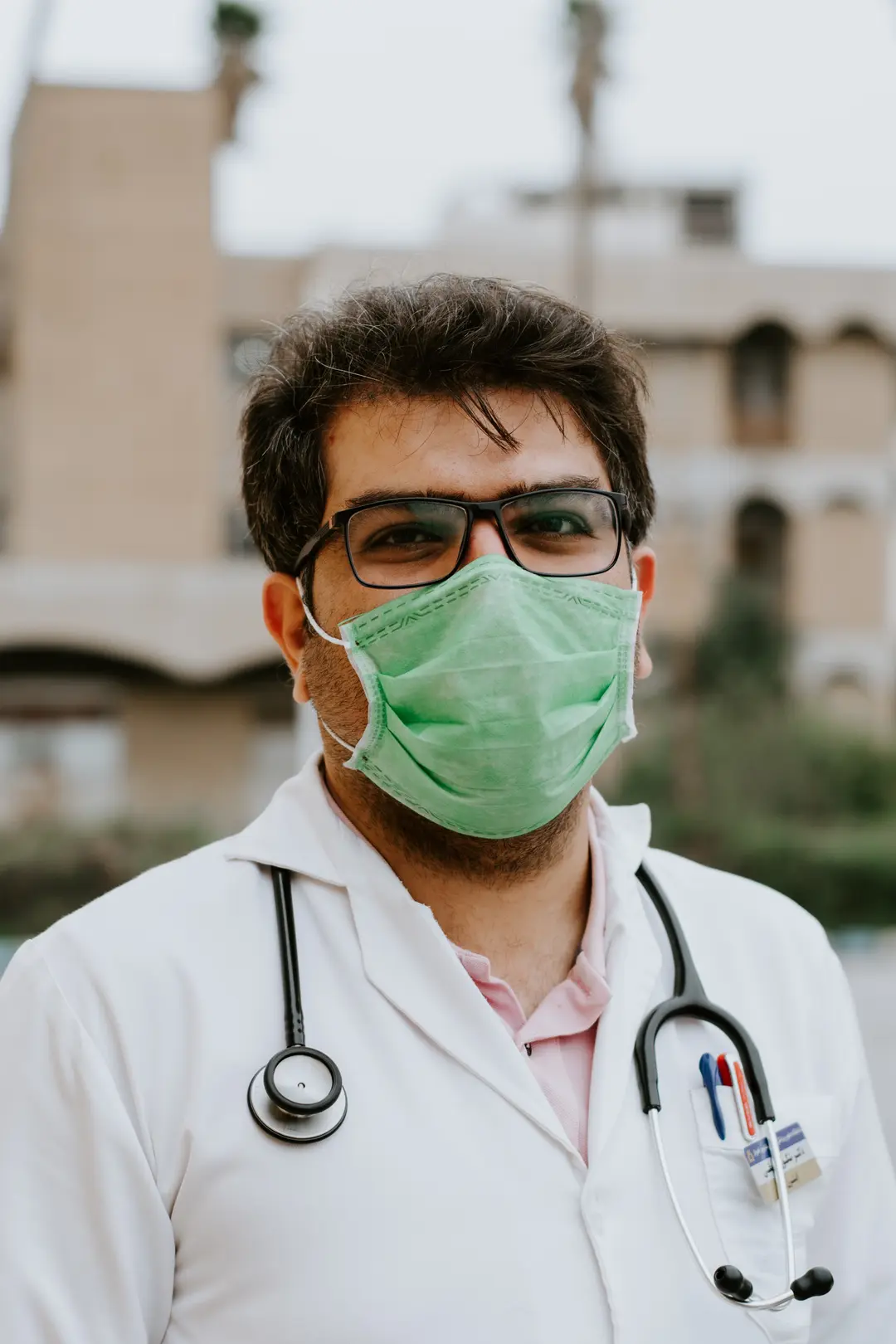 A physician in a mask with a stethoscope
