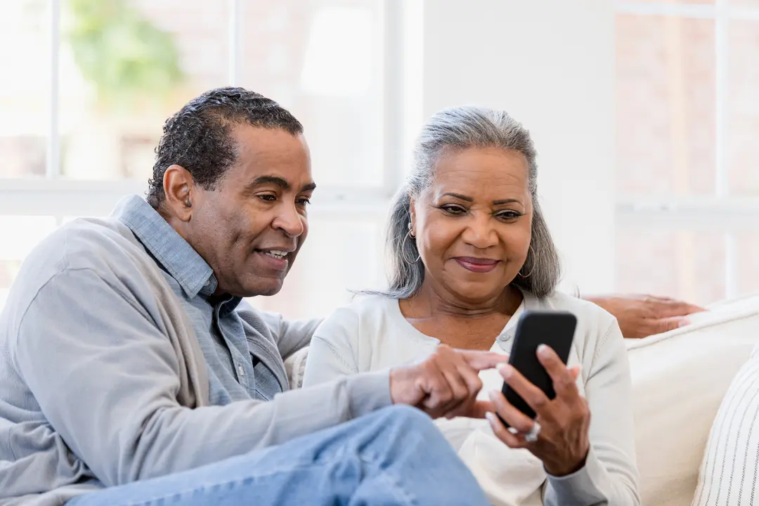 A senior couple looking at a phone together